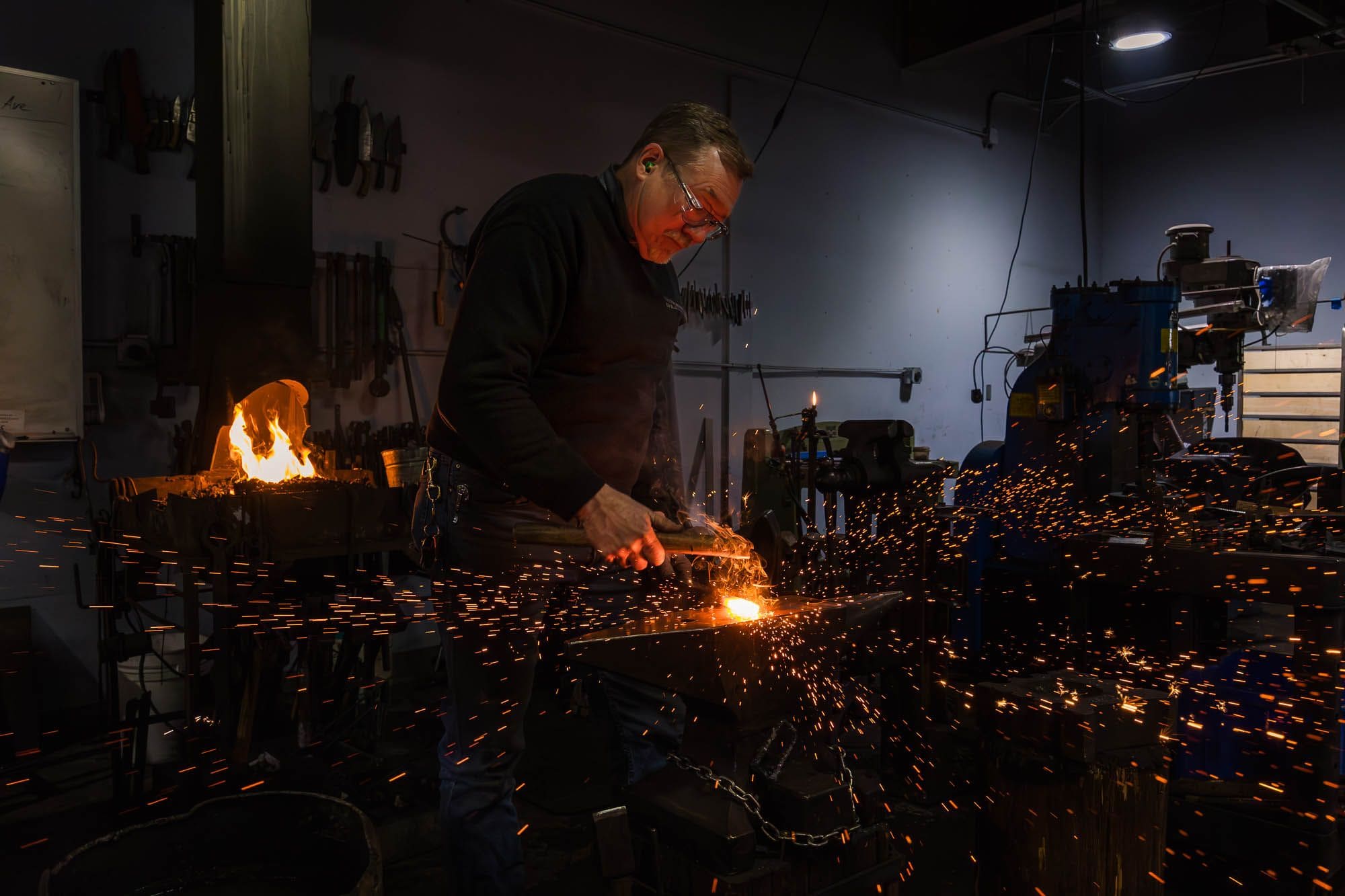 Dale Morse at the anvil, sparks flying