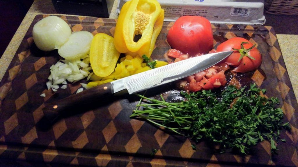 A forged kitchen knife on a cutting board