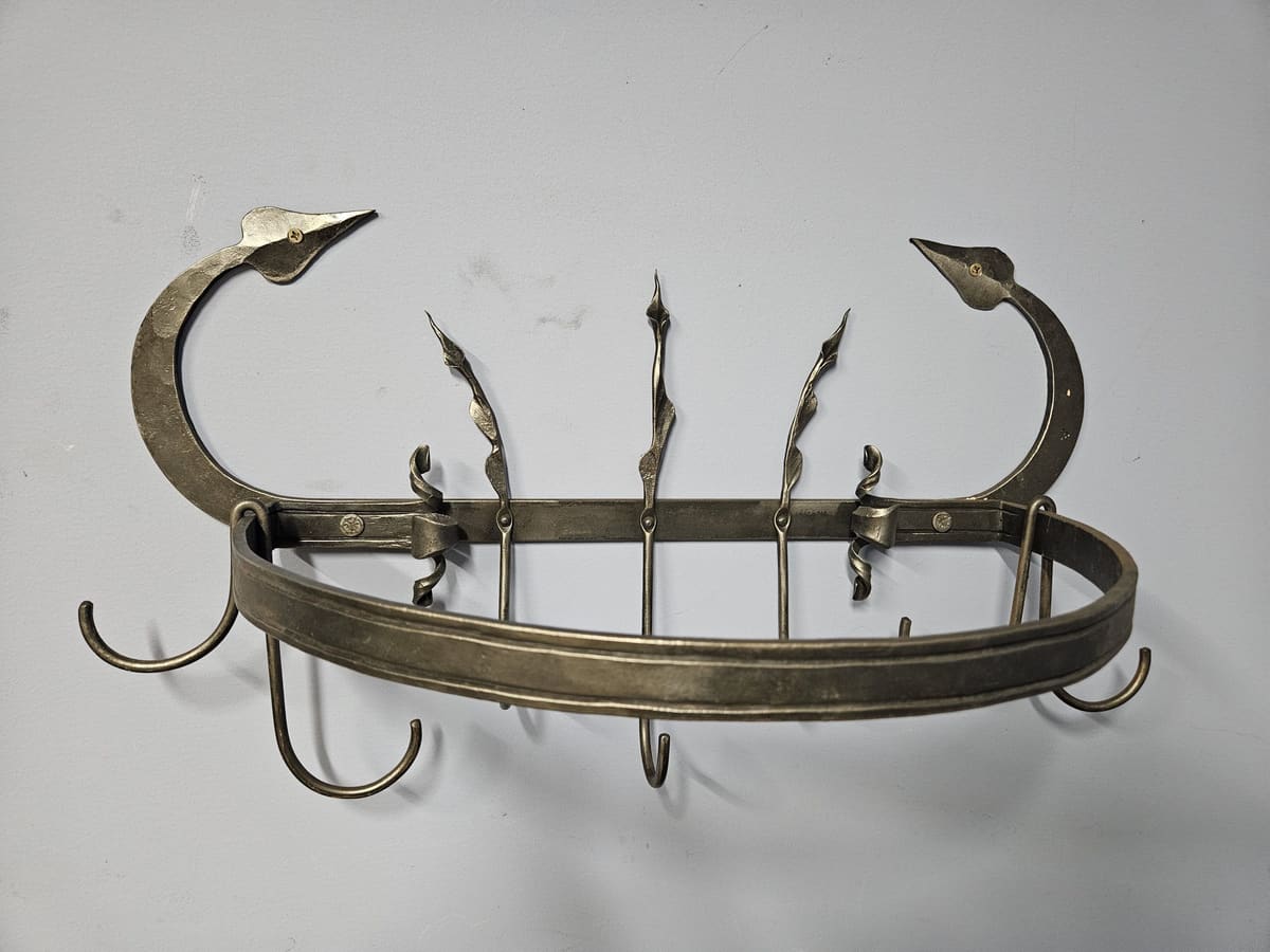 A forged pot rack with twisted hooks