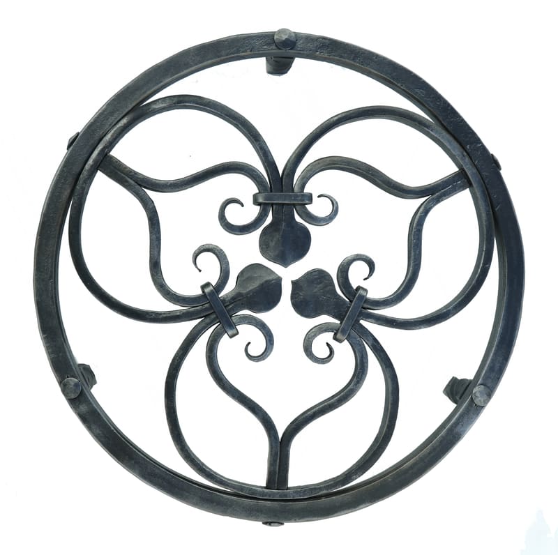A trefoil trivet with scroll and forge welded rings